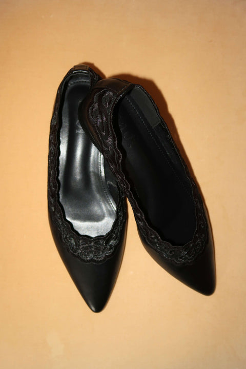 Black pointed-toe flats with lace details 