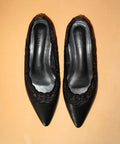 Pair of black pointed-toe shoes with lace