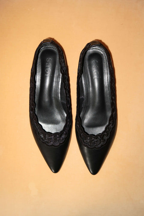 Pair of black pointed-toe shoes with lace